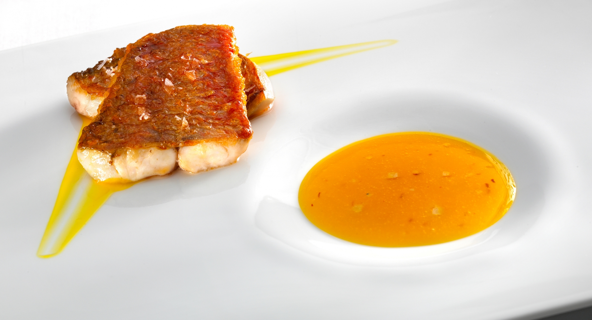 Loin of red mullet "goatfish," toasted and rested. savory confit of rockfish and saffron.  grains of grey salt.
PHOTO: José Luis López de Zubiría / Mugaritz