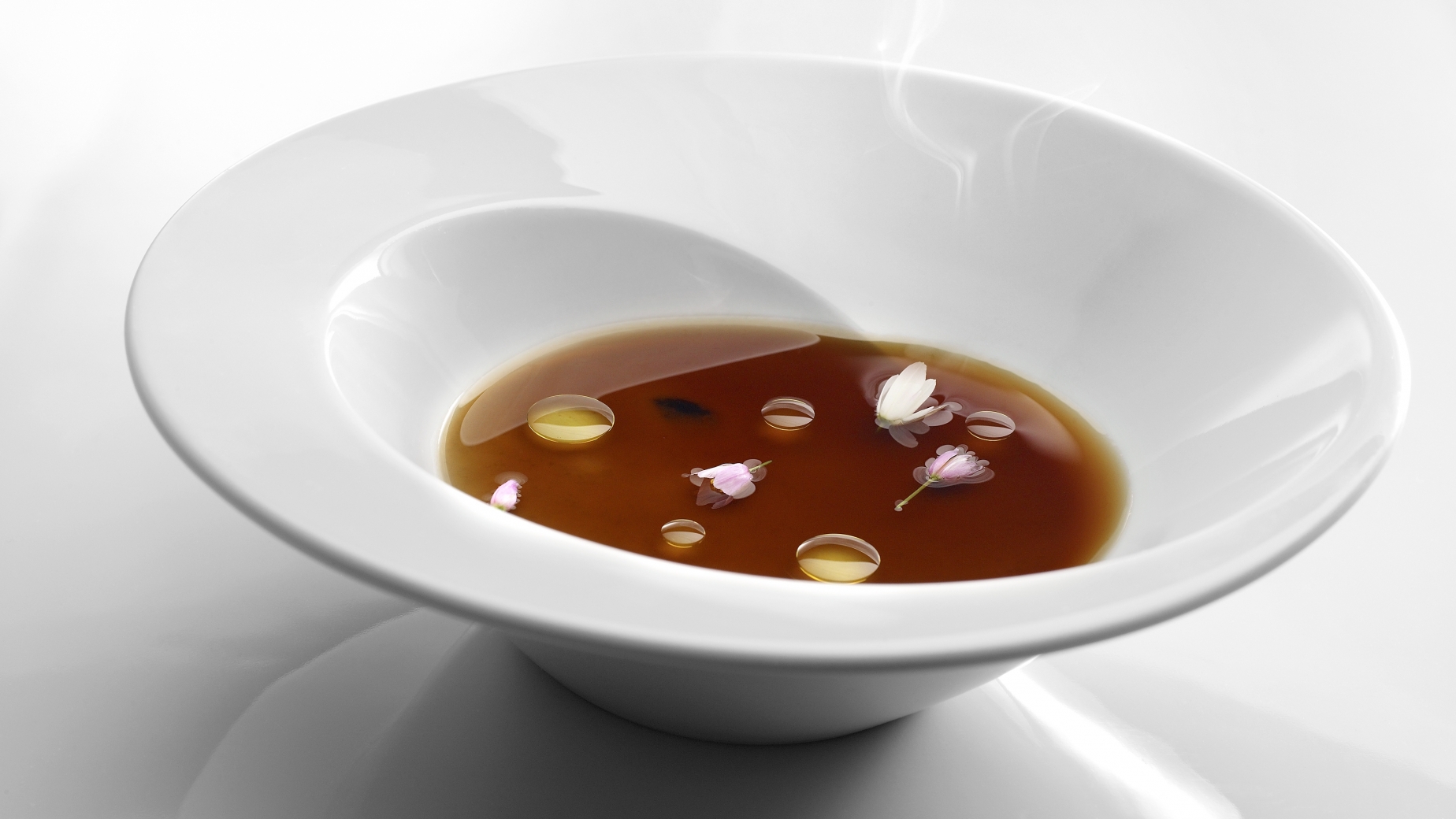 Jellied vegetable stock on a sticky paste of rice and baby squid.
PHOTO: José Luis López de Zubiría / Mugaritz