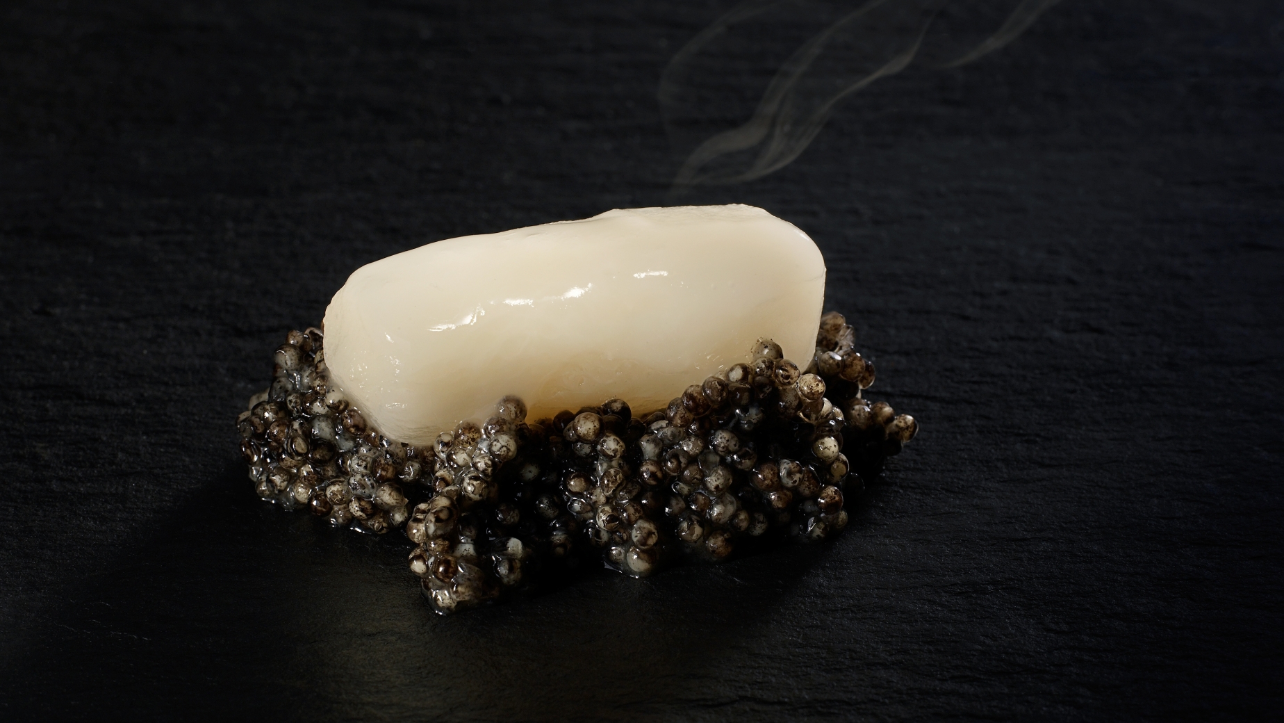 Red radish simmered in a rice broth resting on a spoonful of caviar.
PHOTO: José Luis López de Zubiría / Mugaritz